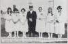 Rev Reitz and confirmation class 1922 outside Church #3 with first City watertower in background, Tillie and rose are daughters of Gus and Mae Gesell